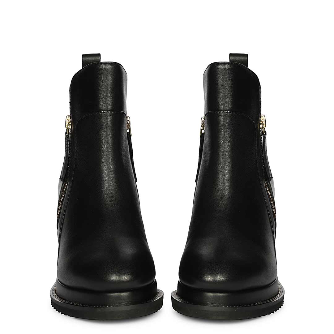 Pair of womens black leather wedge ankle boots, front view