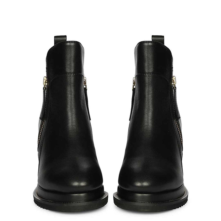 Pair of womens black leather wedge ankle boots, front view