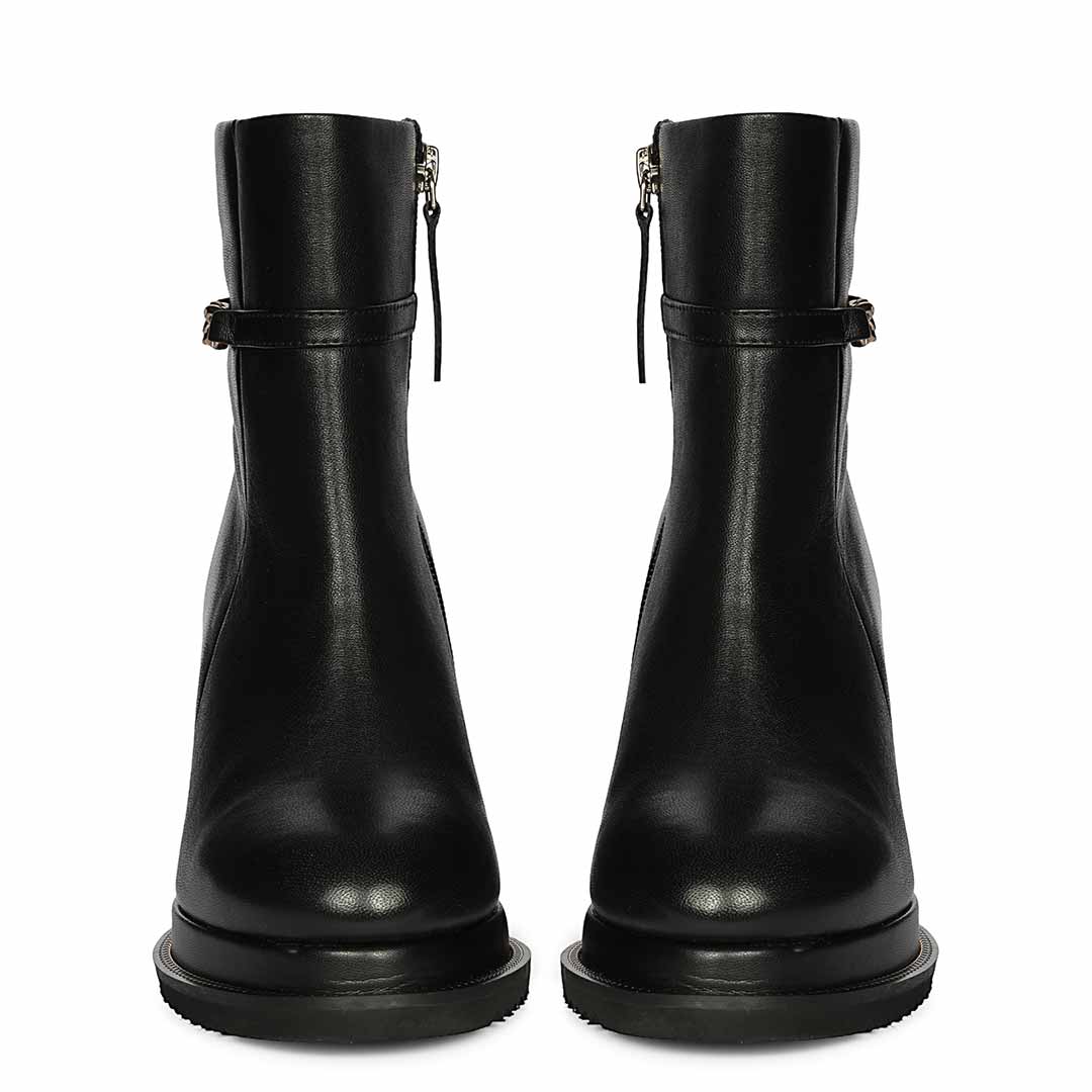 Pair of womens black leather wedge ankle boots, front view