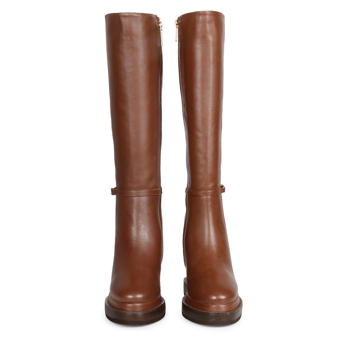 Pair of womens tan leather wedge long boots, front view