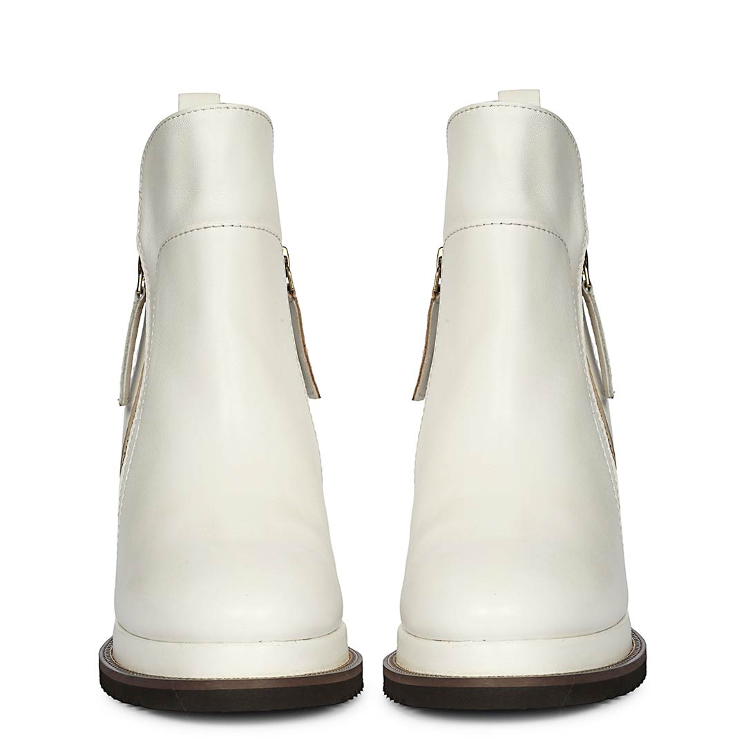 Pair of womens white leather wedge ankle boots, back view