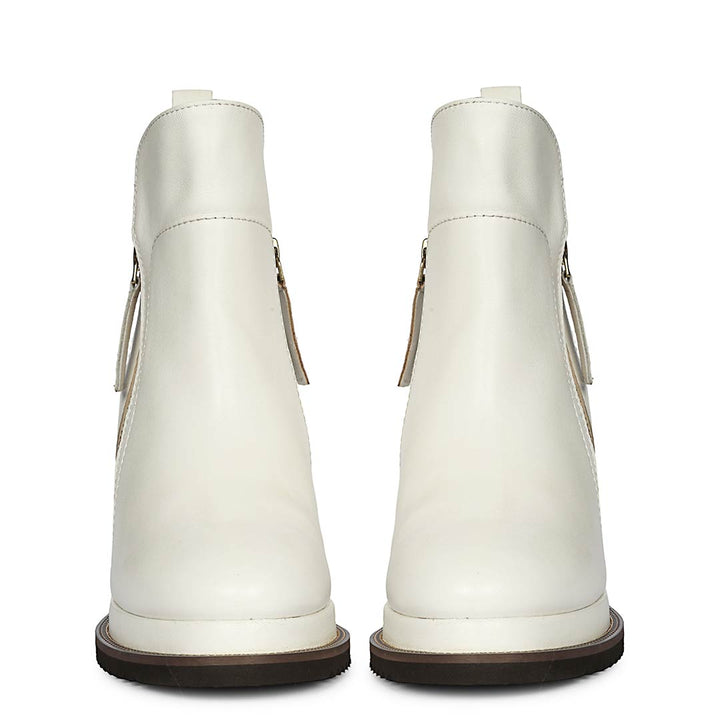 Pair of womens white leather wedge ankle boots, back view